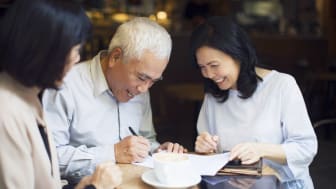 A man signing a document