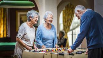 Several people having fun while playing foosball