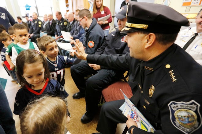 In this file photo, New Bedford police chief Joseph Cordeiro high-fives students. Students of the St. James St. John school held the first annual 1st Responders Appreciation Ceremony at their school in New Bedford, giving thanks to local police officers, firefighters, correctional officers, EMT/Paramedics and City Councilors.