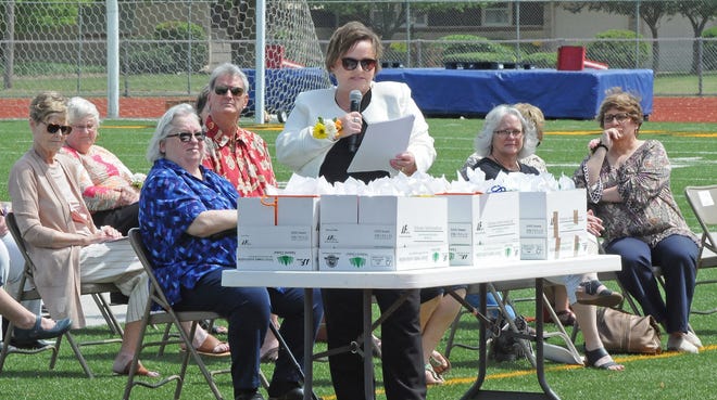Superintendent for USD 305 Salina Public Schools Linn Exline congratulates the 35 teachers and staff members who will be retire after this school year during the retirement recognition ceremony at Salina Stadium on Sunday afternoon.
