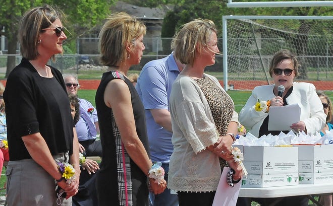 Master Teacher Melanie Hammond, left, Elementary Teacher of the Year JaNae Basinger, and Secondary Teacher of the Year Megan Pommer were recognized for their dedication and years of service to USD 305 Salina Public Schools by Superintendent Linn Exline, right, during the staff recognition ceremony at Salina Stadium on Sunday afternoon.