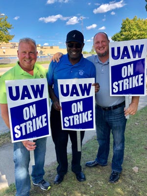 Ron Noble (left) of UAW Local 668 stands with Gerald Kariem (center) during the UAW GM strike in 2019.