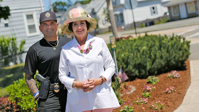 Michele Draicchio Paige maintains the traffic island at South, Summer and Dartmouth streets in Quincy. She's planted flowers and added mulch to the area. Her son Kristopher Kamborian stands to her left.