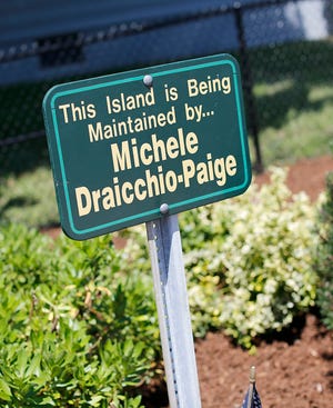 Michele Draicchio Paige maintains the traffic island at South, Summer and Dartmouth streets in Quincy. She's planted flowers and added mulch to the area.