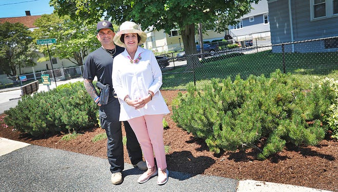 Michele Draicchio Paige maintains the traffic island at South, Summer and Dartmouth streets in Quincy. She's planted flowers and added mulch to the area. Her son Kristopher Kamborian stands to her left.