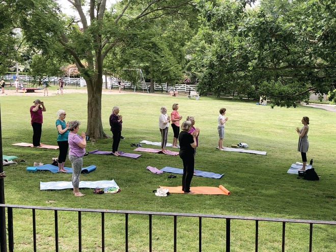 Seniors practice yoga at the Edward King House Senior Center in Newport.