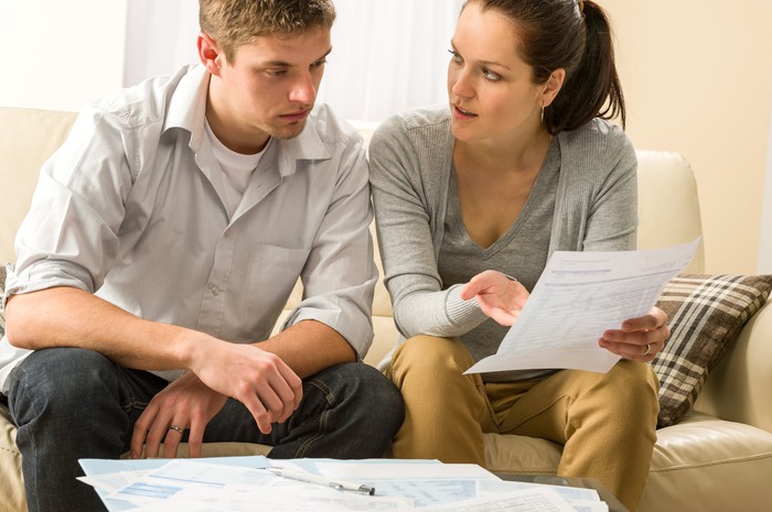 Young couple discussing a document together