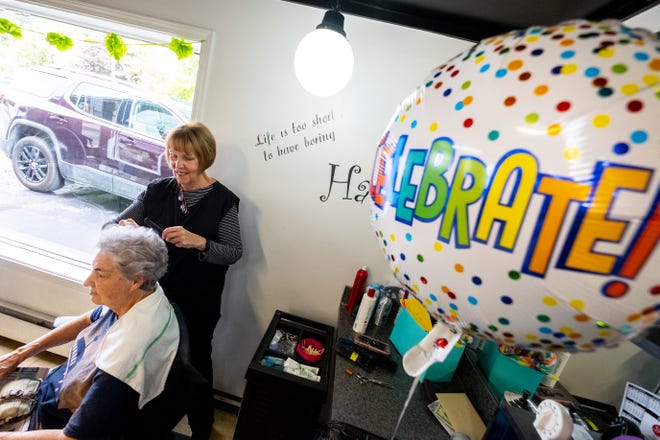 Susan Carrier gives Dovis Lloyd a style Thursday, Sept. 9, 2021, at Shear Style in Marine City. After more than 50 years as a hair dresser, Carrier is retiring.