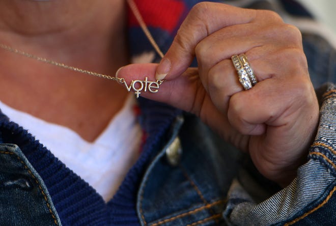 When Susan Ledoux retired from the city of Worcester her staff gave her this necklace. She is now the warden of the Burncoat High School polling place.